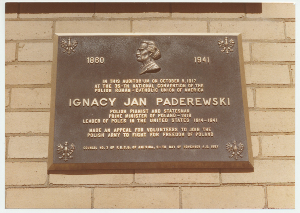 Photographie de la plaque commémorative posée le 5 novembre 1967 sur la façade du St. Mary's School Hall de Schenectady, New York, en mémoire de l'appel lancé dans cette salle, le 8 octobre 1917, par Paderewski aux volontaires polonais d'Amérique