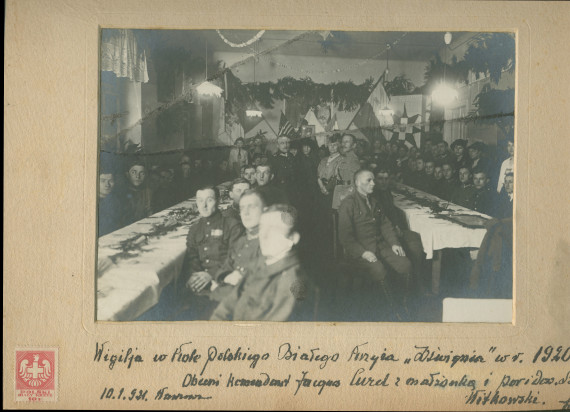 Photographie de la fête de Noël 1920 célébrée en la salle «Dzwignia» (littéralement «du Levier») de la Croix Blanche polonaise (à Varsovie?), avec comme invités le commandant (français?) Jacques Curel, son épouse et un certain Witkowski