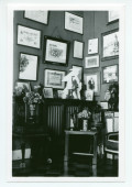 Photographie d'un coin du cabinet des trophées du salon de Riond-Bosson, avec de nombreux encadrements