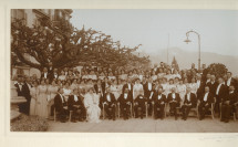 Photographie de groupe (en tenue de soirée), avec Camille Saint-Saëns assis au centre, réalisée sur la terrasse de l'Hôtel des Trois Couronnes à Vevey dans le cadre des Fêtes musicales données en mai 1913 en l'honneur de Camille Saint-Saëns